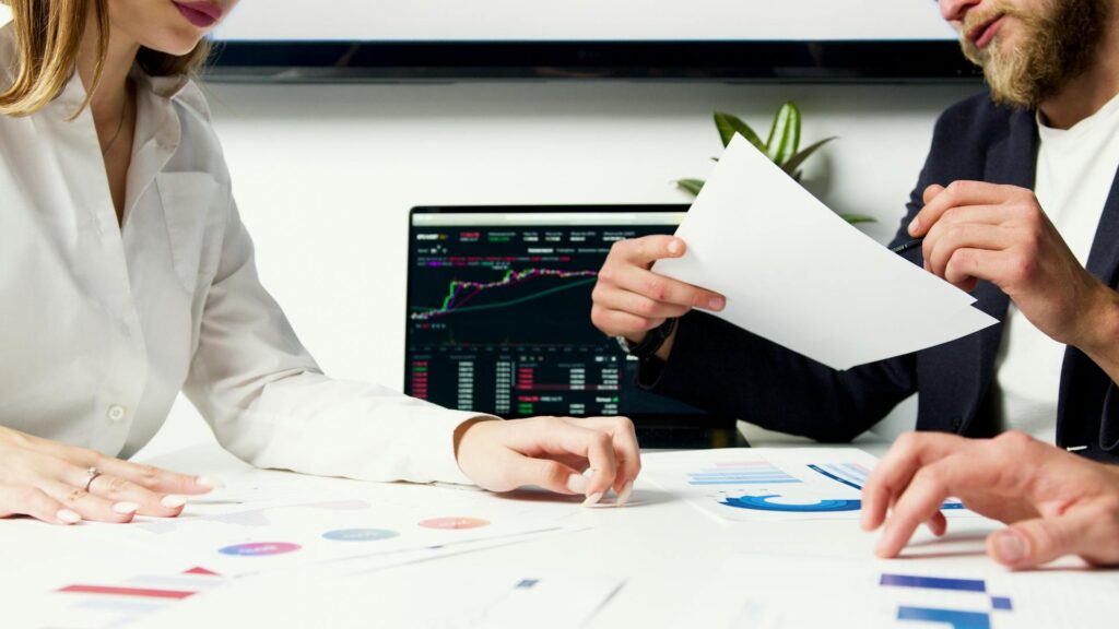 Investor reviewing financial documents for QSBS tax benefits under IRC Section 1202 at a modern desk.